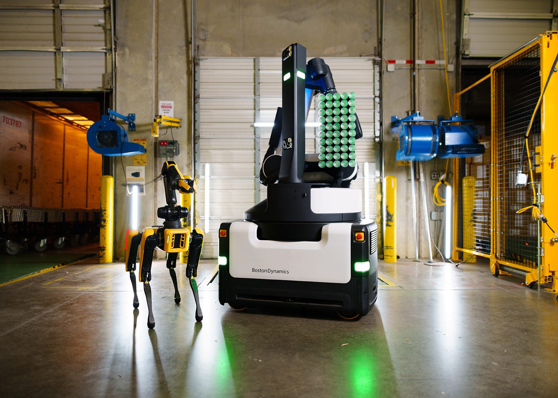 Commercial robots, Spot and Stretch, side by side in a warehouse